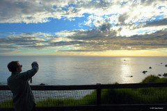 Person taking picture of ocean sunset at Esalen